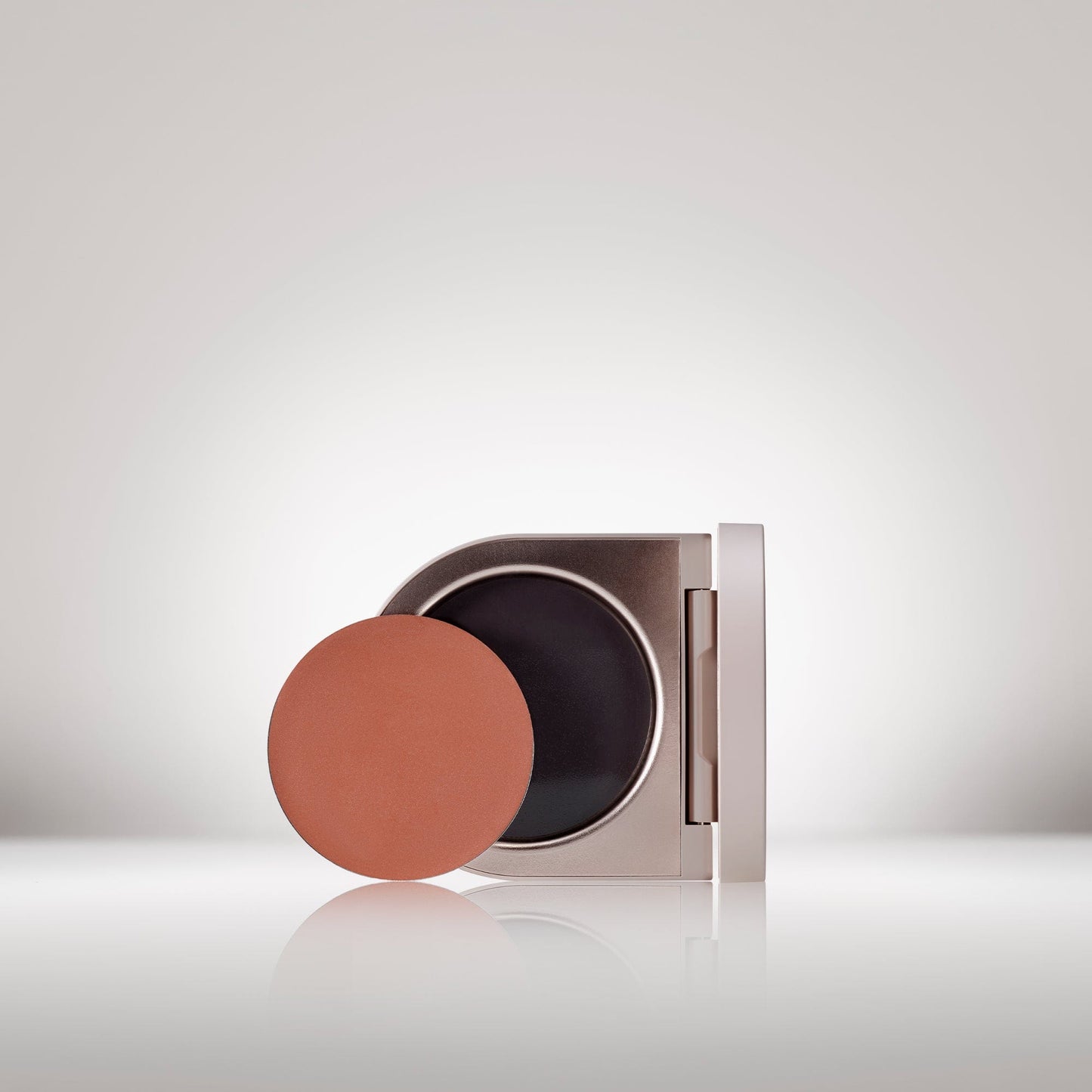 Image of the Cream Blush Refillable Cheek & Lip Color in Delphine in front of the open compact - Cream blush