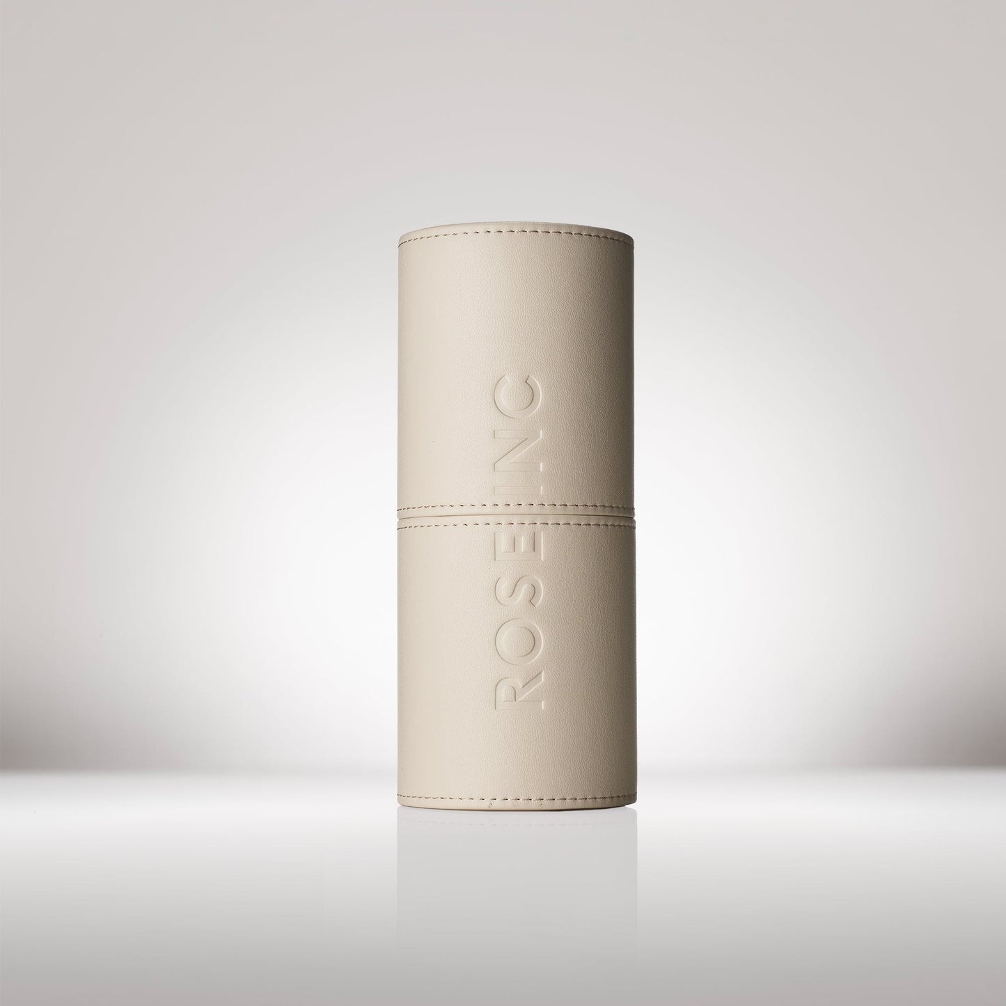 Signature Rose Inc Vegan Leather Brush Cup in a cylinder shape. Shown closed revealed the embossed Rose Inc logo